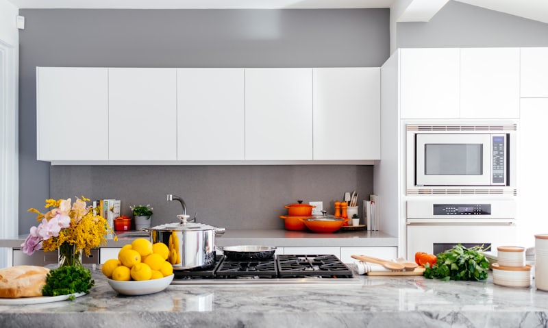 Renovated kitchen with white cabinets and stone countertop